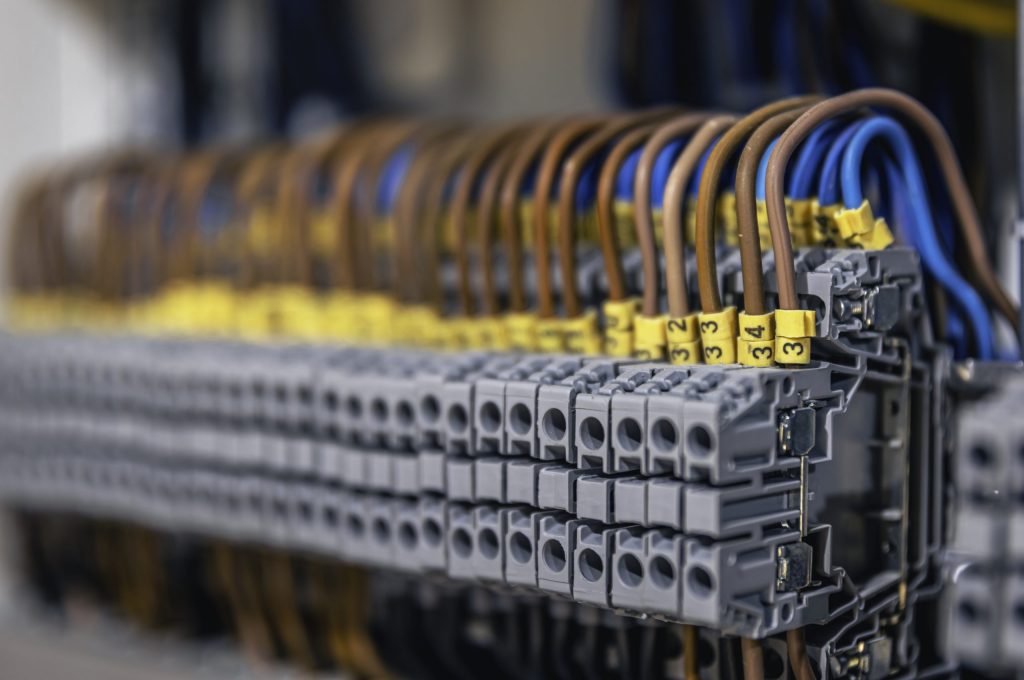 Voltage distributor with automatic switches. Electrical background.